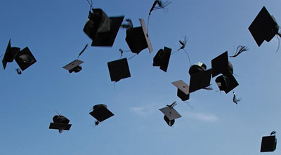 Graduation hats thrown in the air