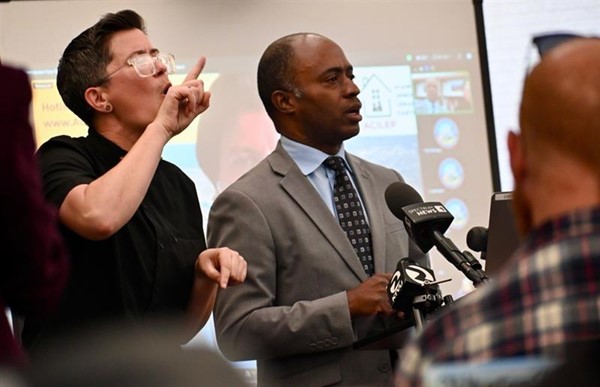 Left to right, an American Sign Language interpreter and State Superintendent Tony Thurmond.